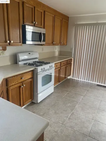 a kitchen with a stove microwave and sink