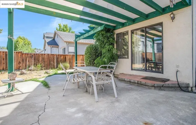 a view of a patio with table and chairs and potted plants