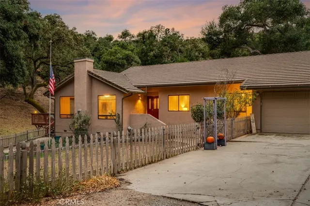 a view of a house with wooden fence