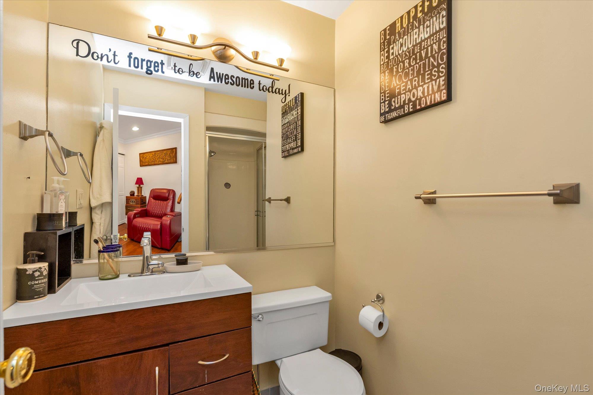 150 I U Willets Road Albertson, NY 11507 - Photo 18 of 21 2nd bathroom featuring a wood-finish vanity with an integrated sink, full shower, a large wall-mounted mirror, and a wall-mounted light fixture