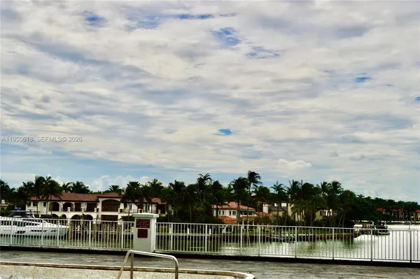a view of swimming pool with outdoor seating and buildings in the background