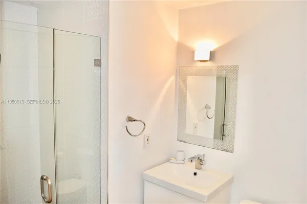 a bathroom with a sink a mirror and a shower