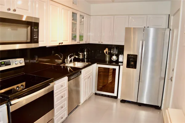 a kitchen with a refrigerator and a stove