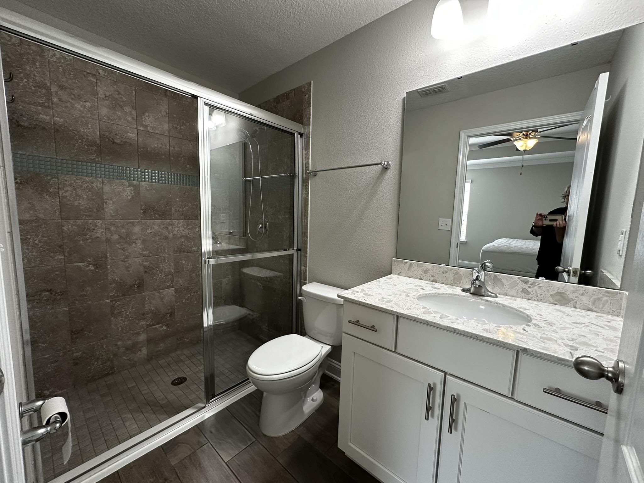 116 Coastal Hammock Way St. Augustine, FL 32086 - Photo 11 of 13 a bathroom with a granite countertop sink toilet and shower