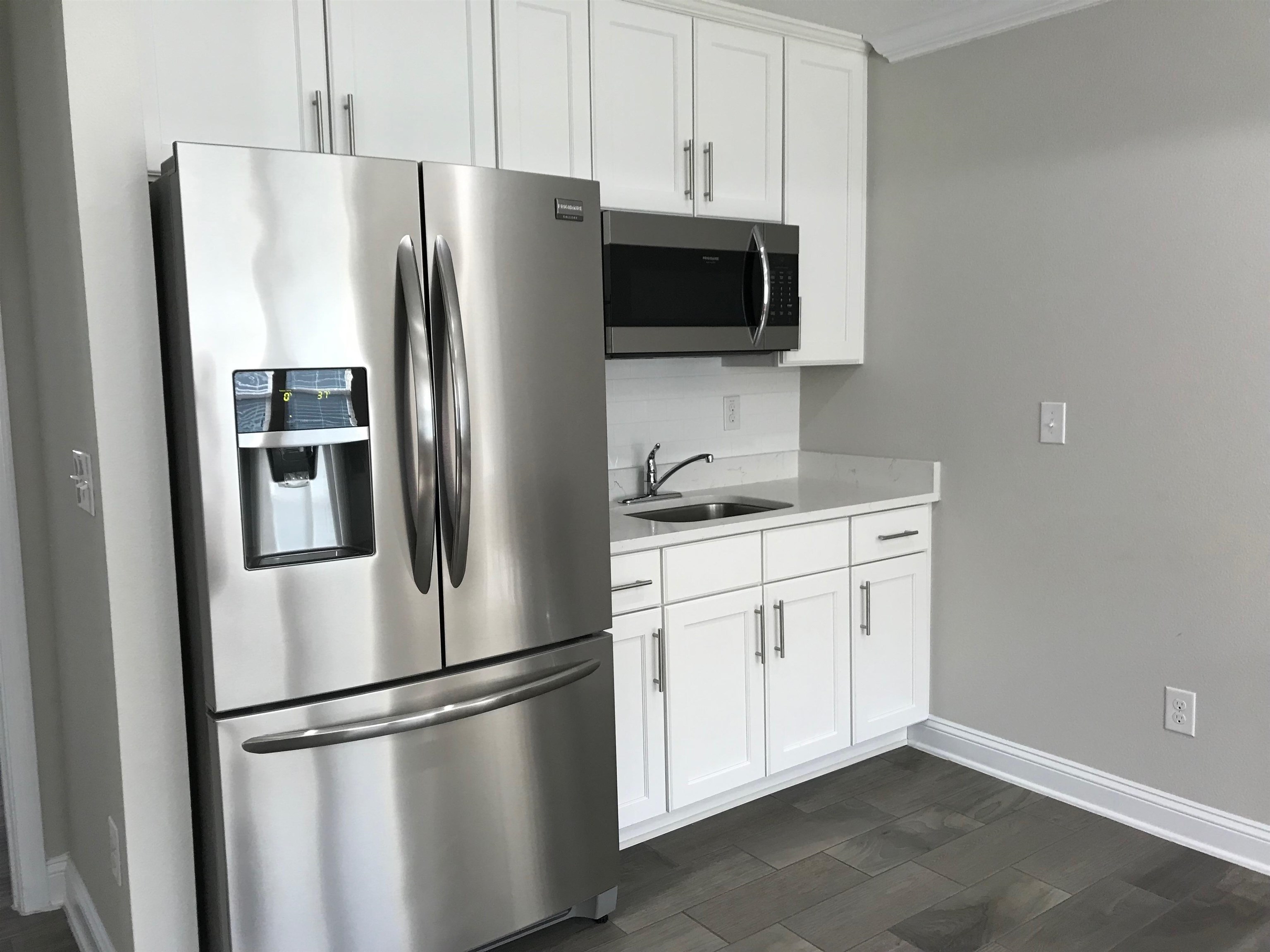 116 Coastal Hammock Way St. Augustine, FL 32086 - Photo 2 of 13 a white refrigerator freezer sitting in a kitchen