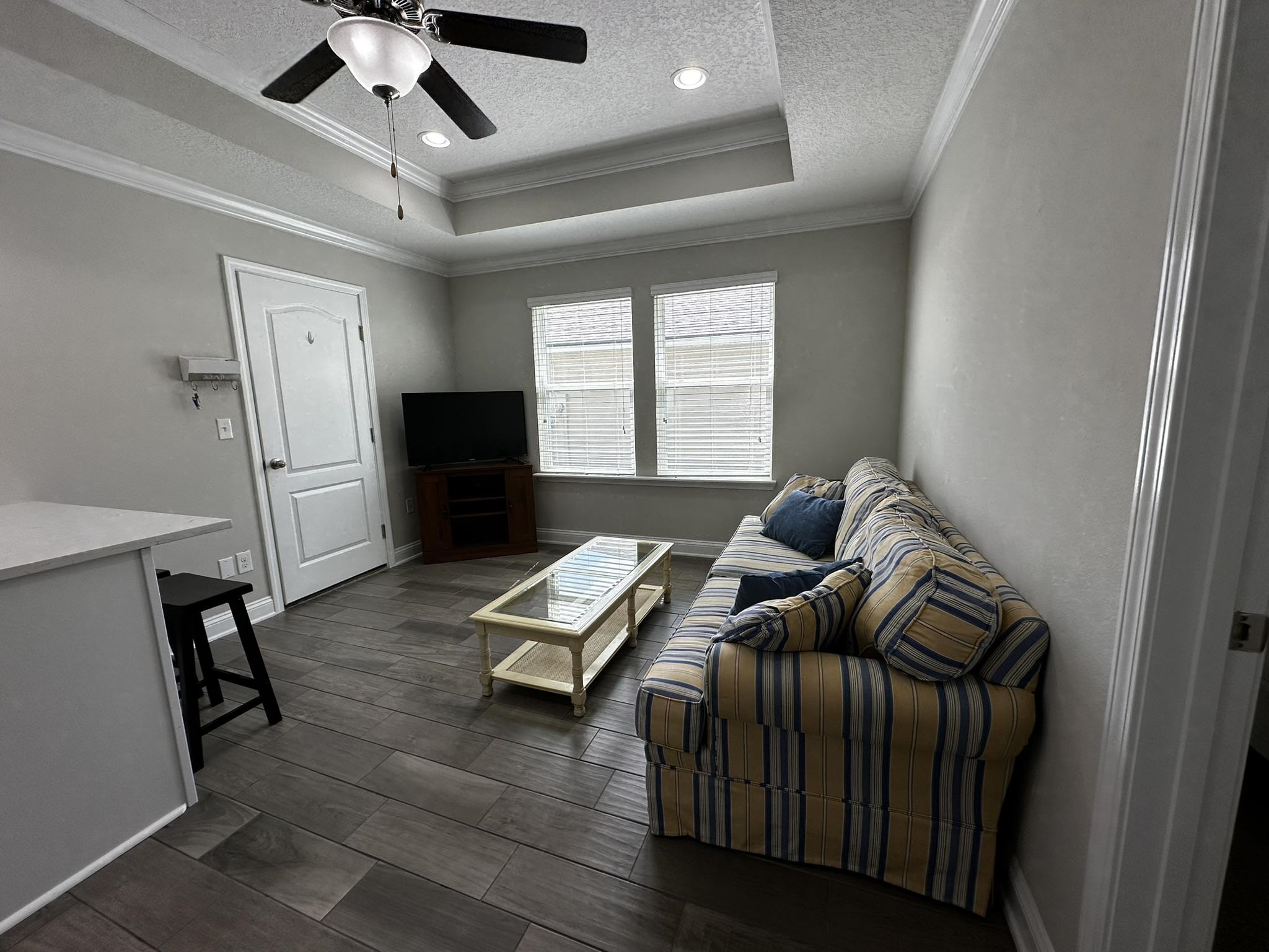 116 Coastal Hammock Way St. Augustine, FL 32086 - Photo 3 of 13 a living room with furniture and a flat screen tv