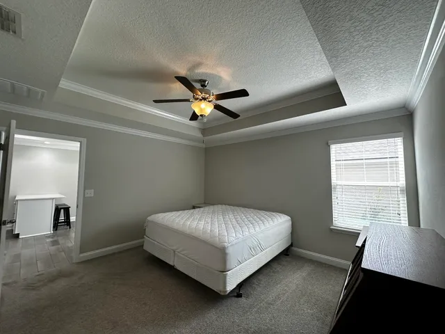 a bed sitting in a bedroom next to a window