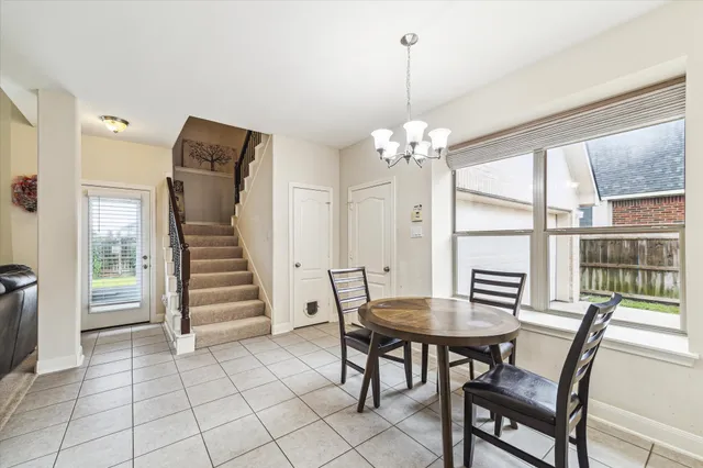 a view of a dining room with furniture wooden floor and chandelier
