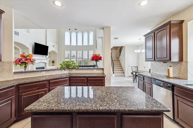 a kitchen with stainless steel appliances granite countertop a sink and a stove