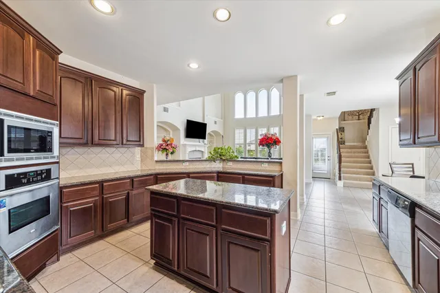 a kitchen with stainless steel appliances granite countertop a stove sink and cabinets