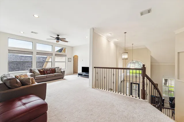 a view of a livingroom with a ceiling fan and window
