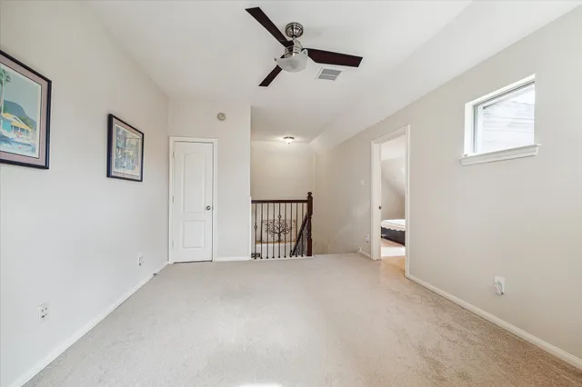 a bed room with a bed and a ceiling fan