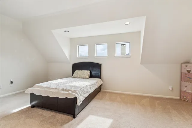 a living room with a bed furniture and a window