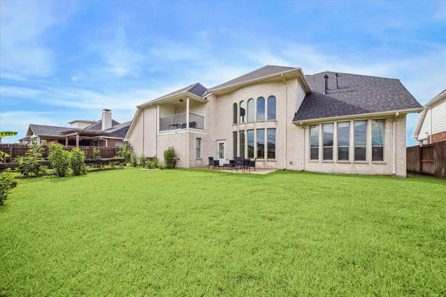 a view of a lake with a big yard and large trees