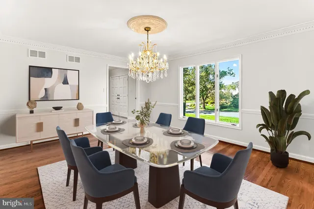a view of a dining room with furniture a chandelier and wooden floor