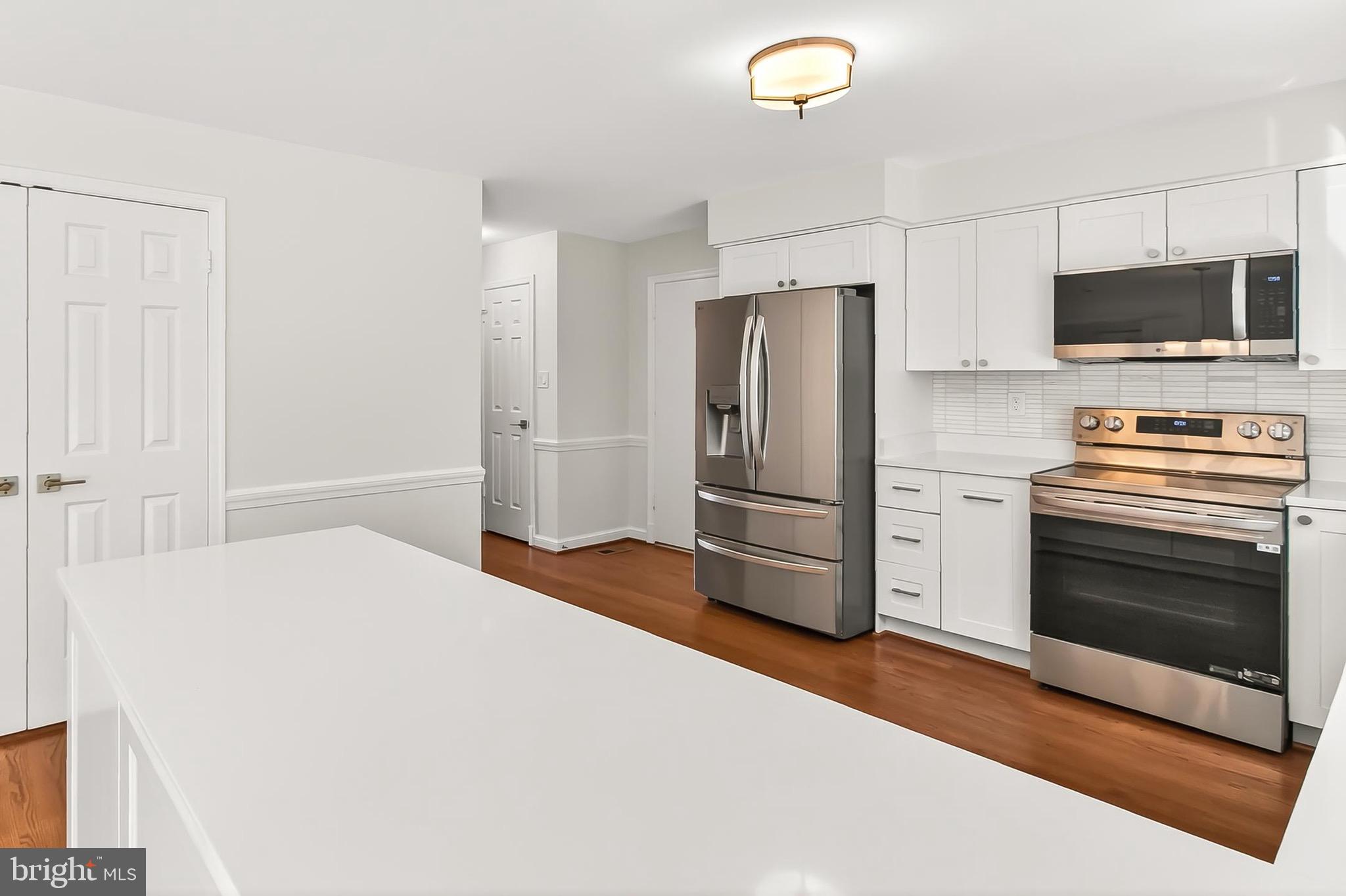 6294 Dunaway Court McLean, VA 22101 - Photo 18 of 76 a kitchen with stainless steel appliances a refrigerator stove and microwave