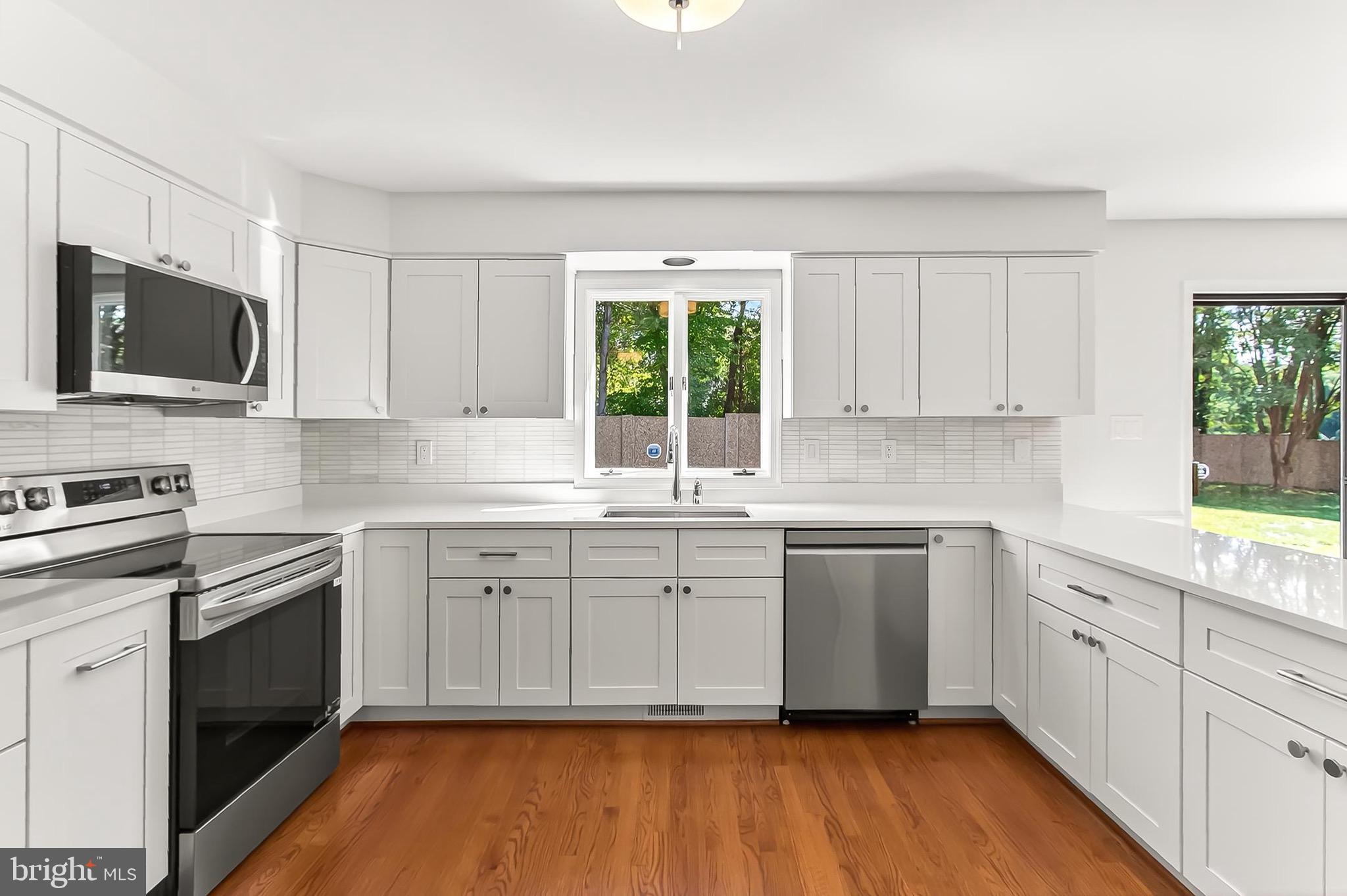 6294 Dunaway Court McLean, VA 22101 - Photo 19 of 76 a kitchen with cabinets stainless steel appliances a sink and a window