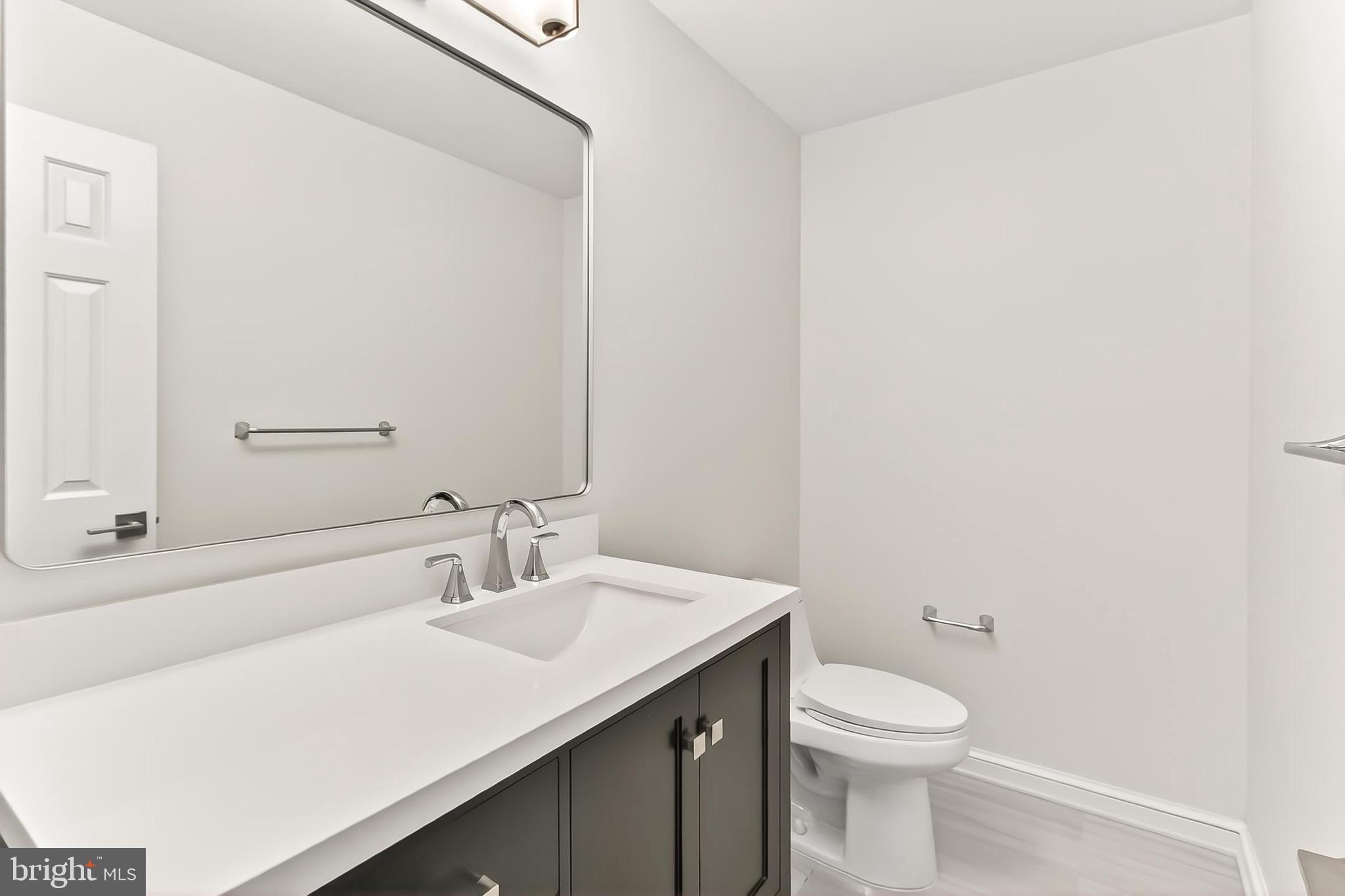6294 Dunaway Court McLean, VA 22101 - Photo 28 of 76 a bathroom with a sink a toilet and a mirror