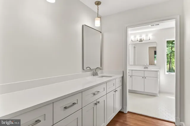 a bathroom with a shower sink and mirror