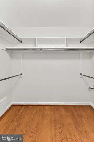 an empty room with fireplace and fan