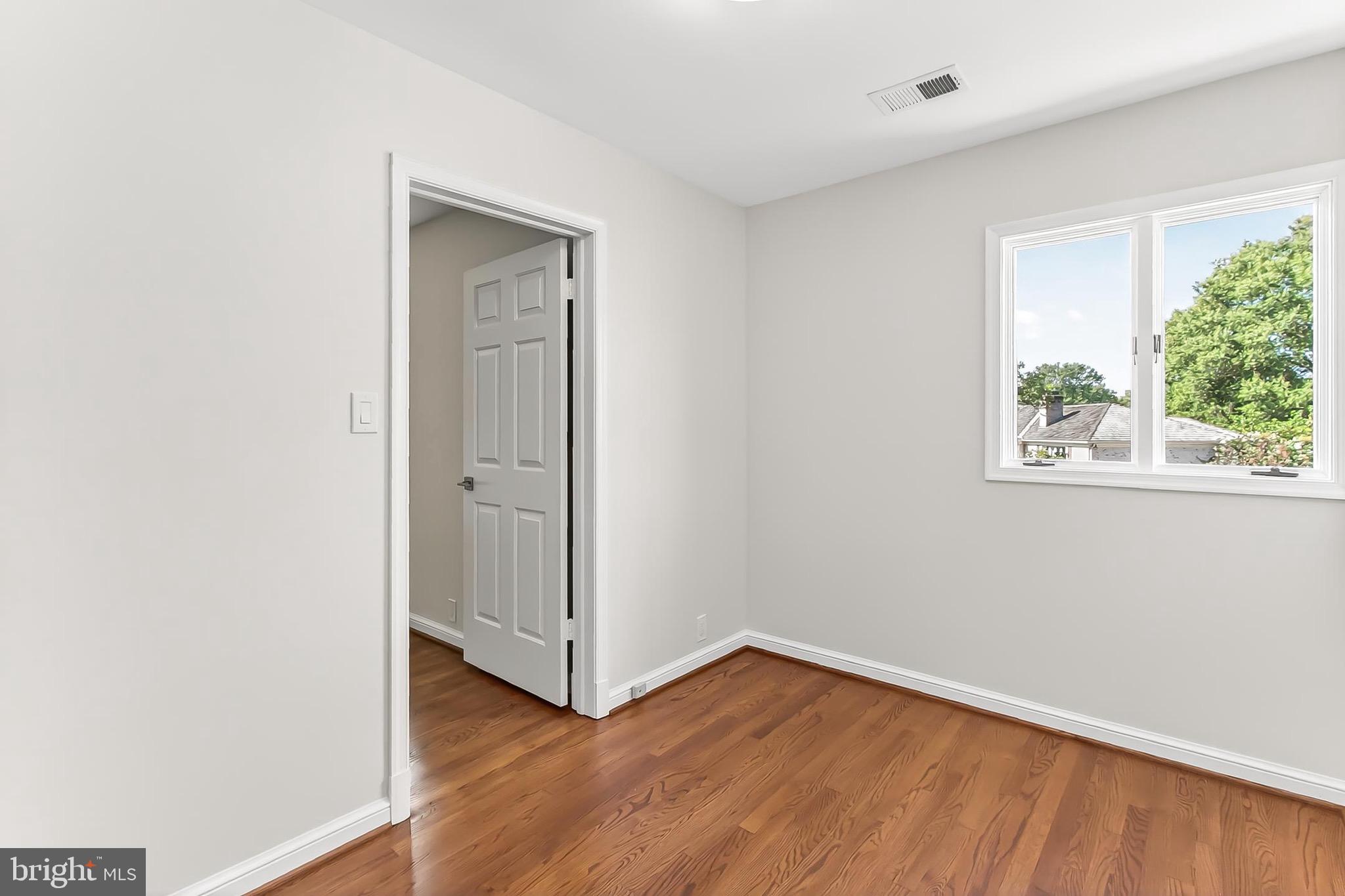 6294 Dunaway Court McLean, VA 22101 - Photo 38 of 76 an empty room with wooden floor and windows