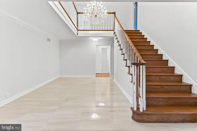 an empty room with wooden floor and fireplace