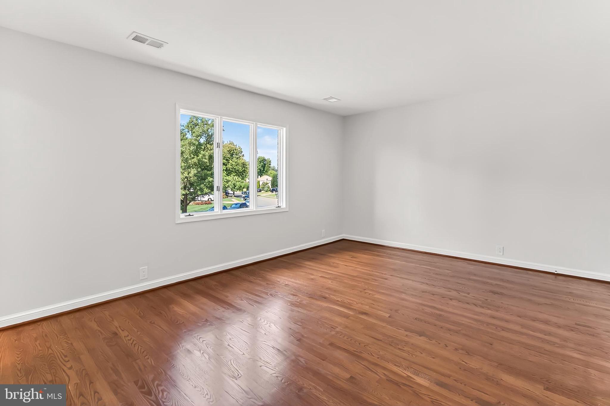 6294 Dunaway Court McLean, VA 22101 - Photo 46 of 76 a view of an empty room with wooden floor and a window