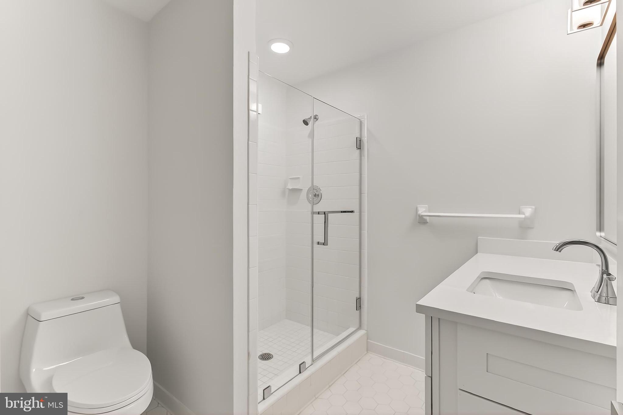 6294 Dunaway Court McLean, VA 22101 - Photo 62 of 76 a bathroom with a toilet sink and shower