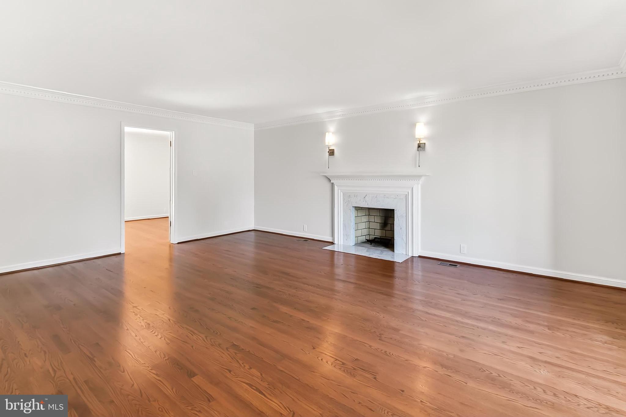 6294 Dunaway Court McLean, VA 22101 - Photo 7 of 76 an empty room with wooden floor and fireplace