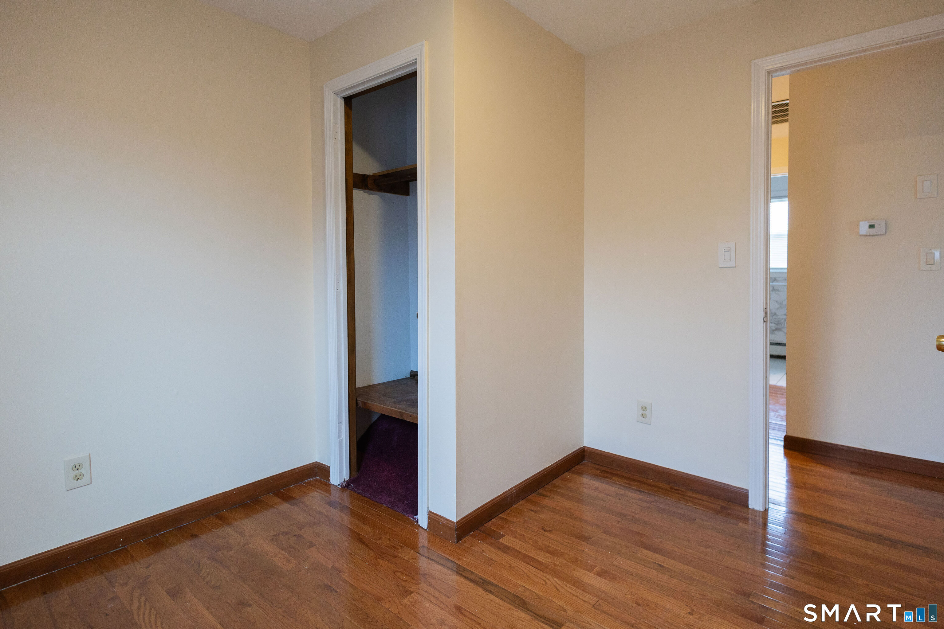 138 Infield Street Bridgeport, CT 06606 - Photo 18 of 34 a view of an empty room with wooden floor