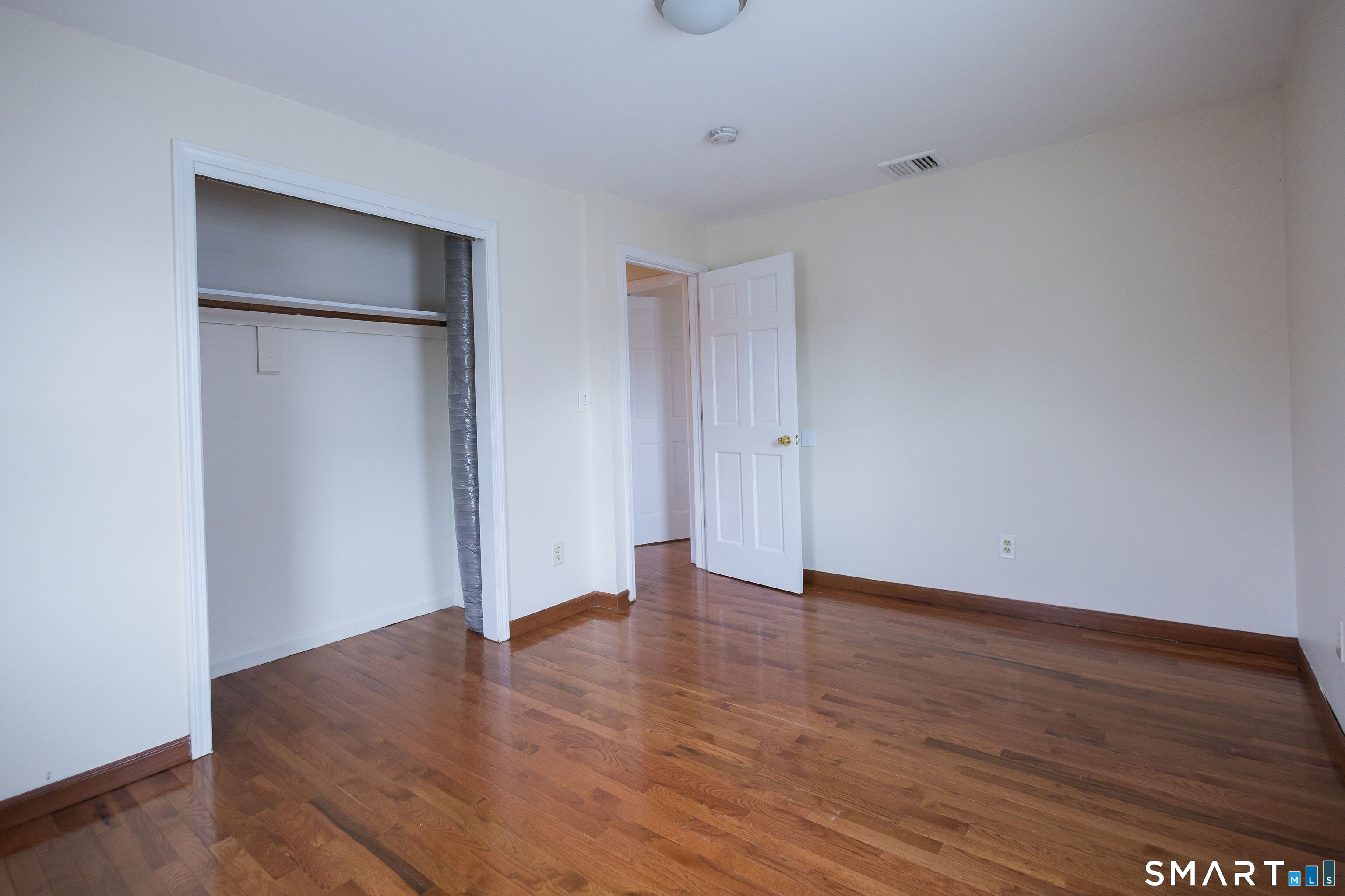 138 Infield Street Bridgeport, CT 06606 - Photo 20 of 34 a view of an empty room with wooden floor