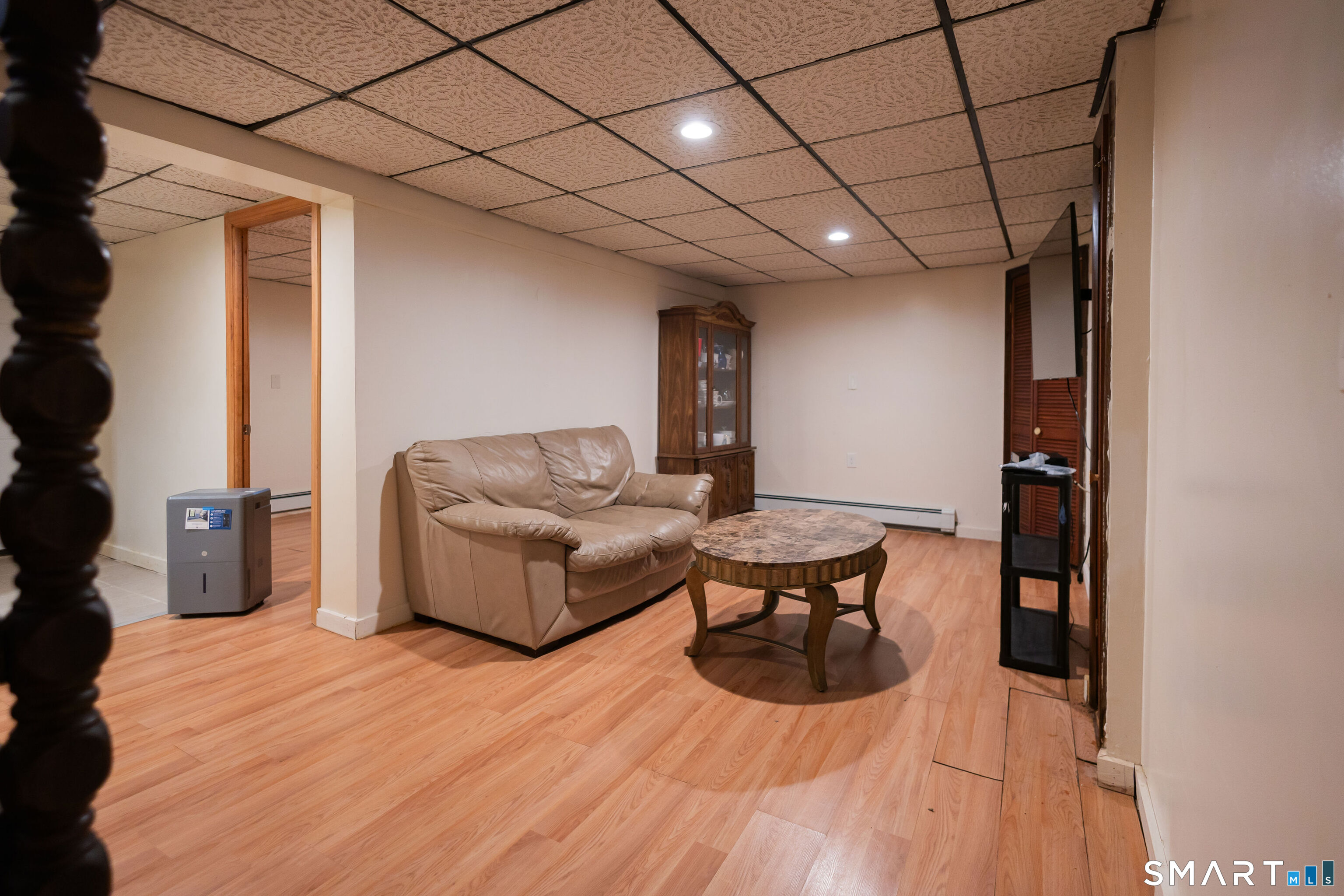 138 Infield Street Bridgeport, CT 06606 - Photo 26 of 34 a living room with furniture a flat screen tv and a wooden floor