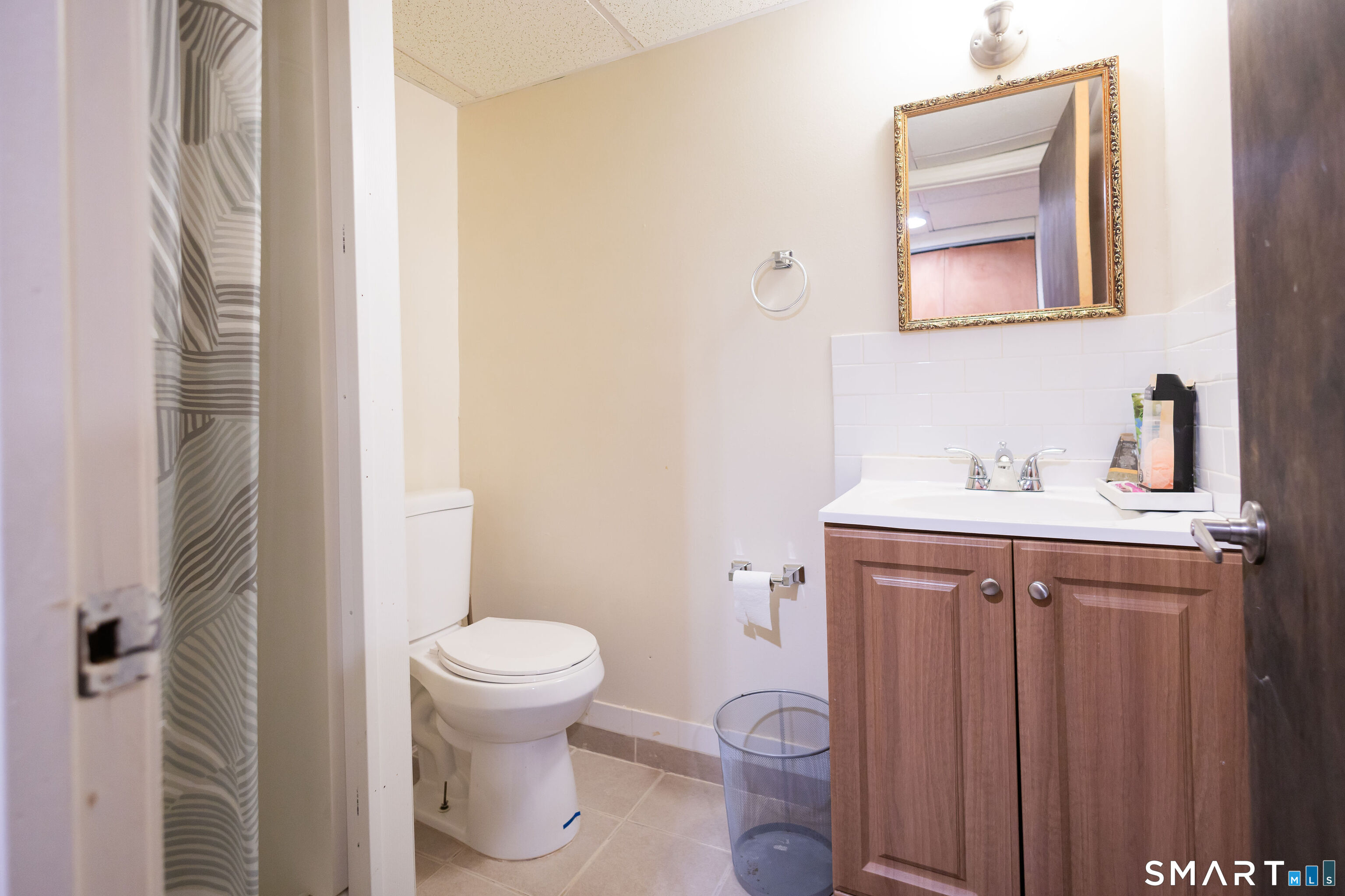 138 Infield Street Bridgeport, CT 06606 - Photo 30 of 34 a bathroom with a sink toilet and a mirror