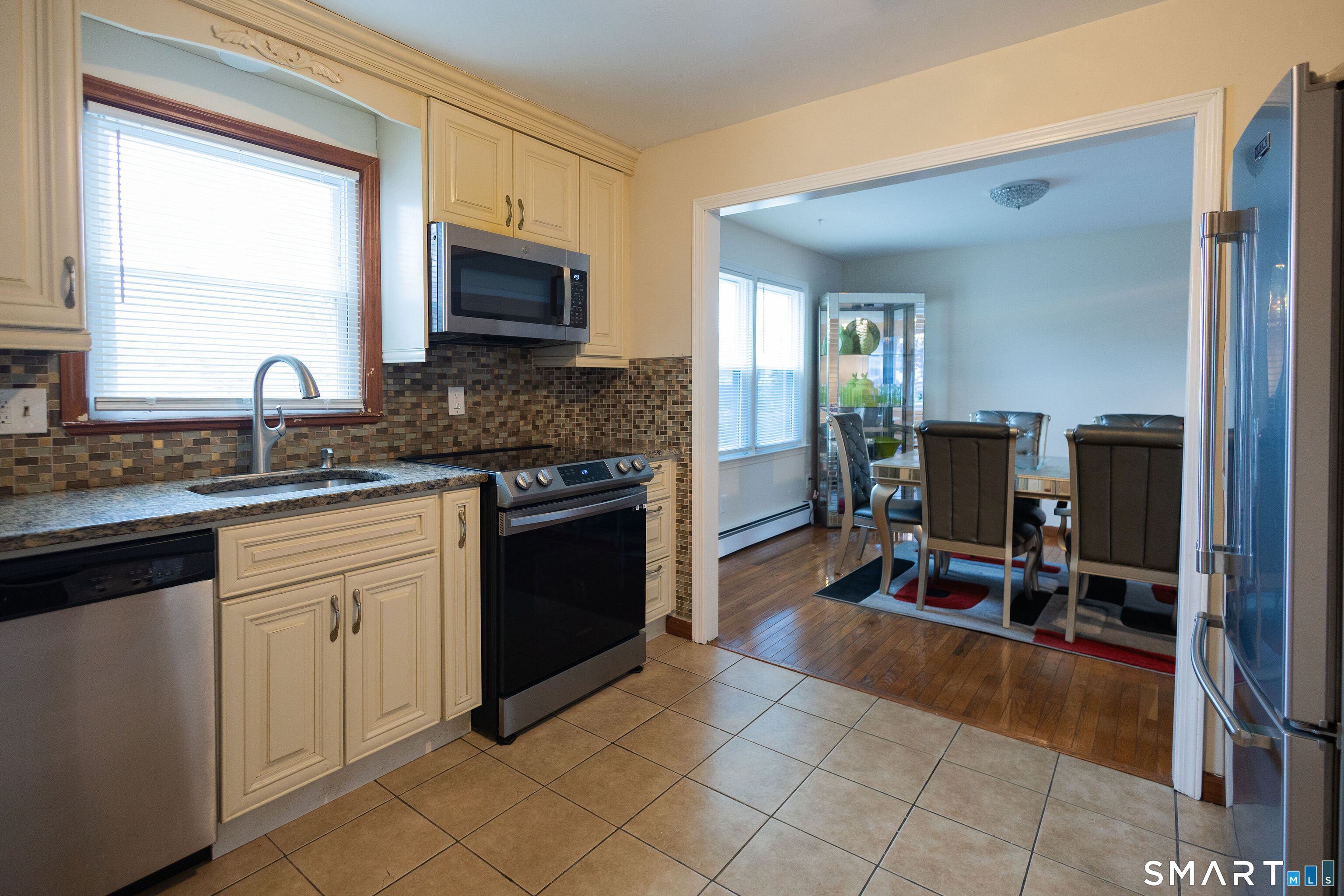 138 Infield Street Bridgeport, CT 06606 - Photo 6 of 34 a kitchen with stainless steel appliances granite countertop a stove a sink and a microwave