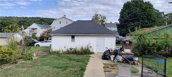 a view of a house with sitting area and garden