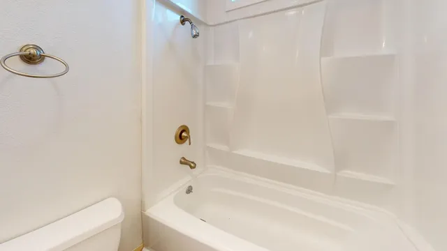 a bathroom with a bathtub and shower