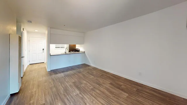 a view of kitchen and wooden floor
