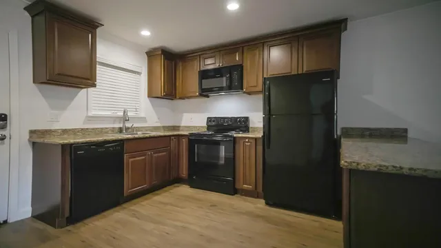 a kitchen with granite countertop stainless steel appliances and wooden cabinets