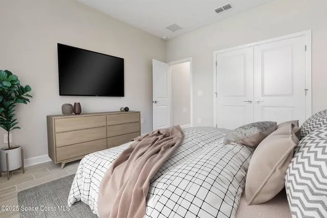 a bedroom with a bed and a flat screen tv