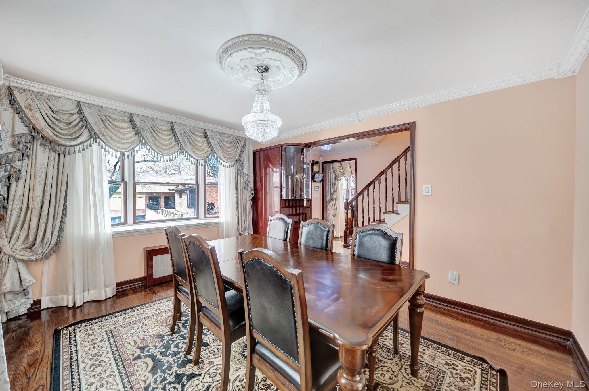 87-67 Chevy Chase Street Queens, NY 11432 - Photo 15 of 31 a view of a dining room with furniture and wooden floor