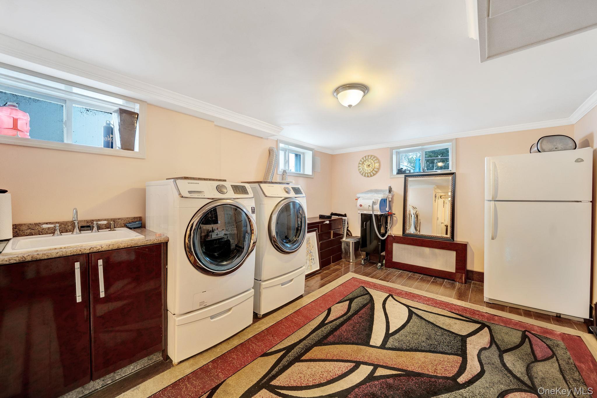 87-67 Chevy Chase Street Queens, NY 11432 - Photo 26 of 31 a utility room with sink dryer and washer
