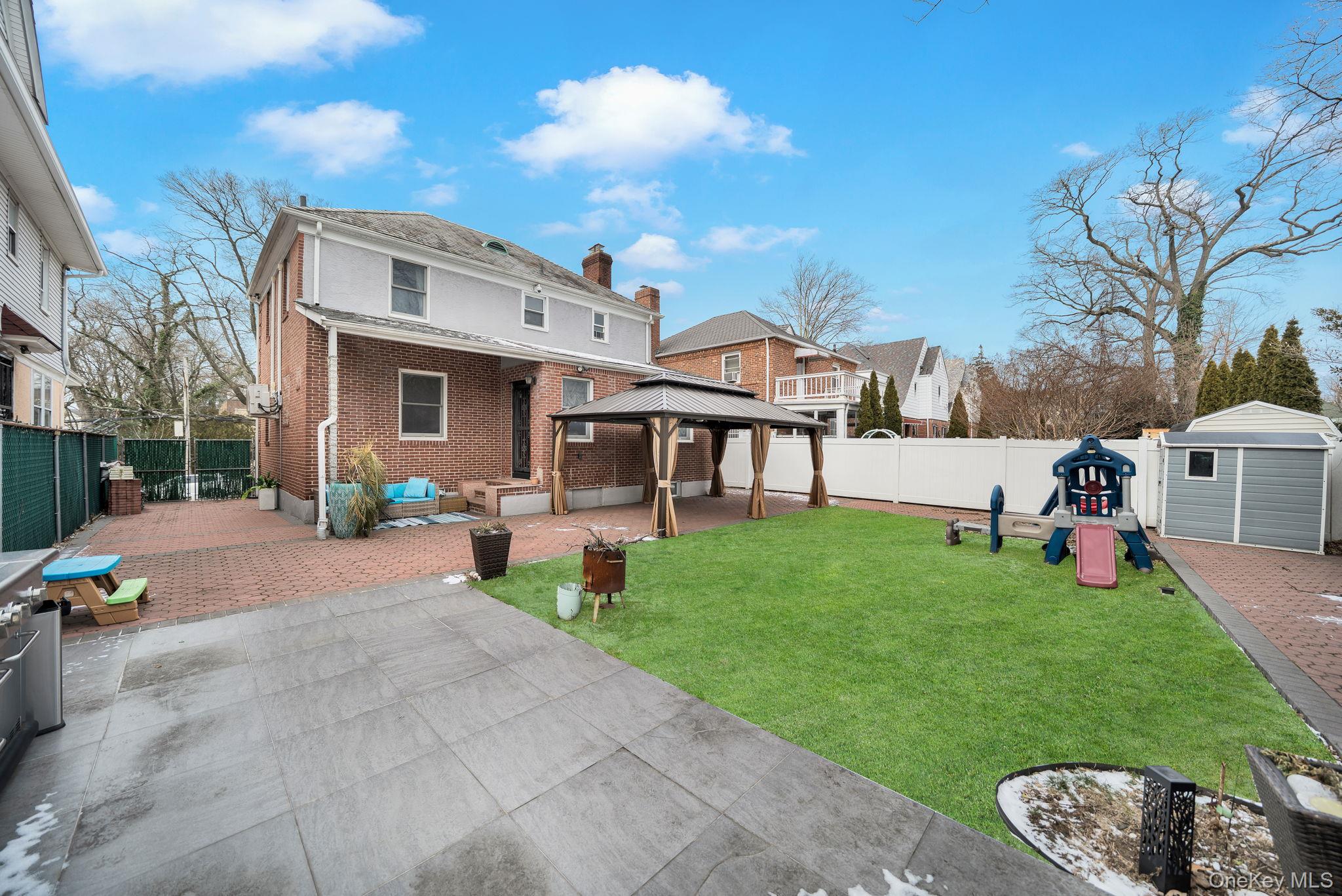 87-67 Chevy Chase Street Queens, NY 11432 - Photo 30 of 31 a view of a house with a yard porch and sitting area