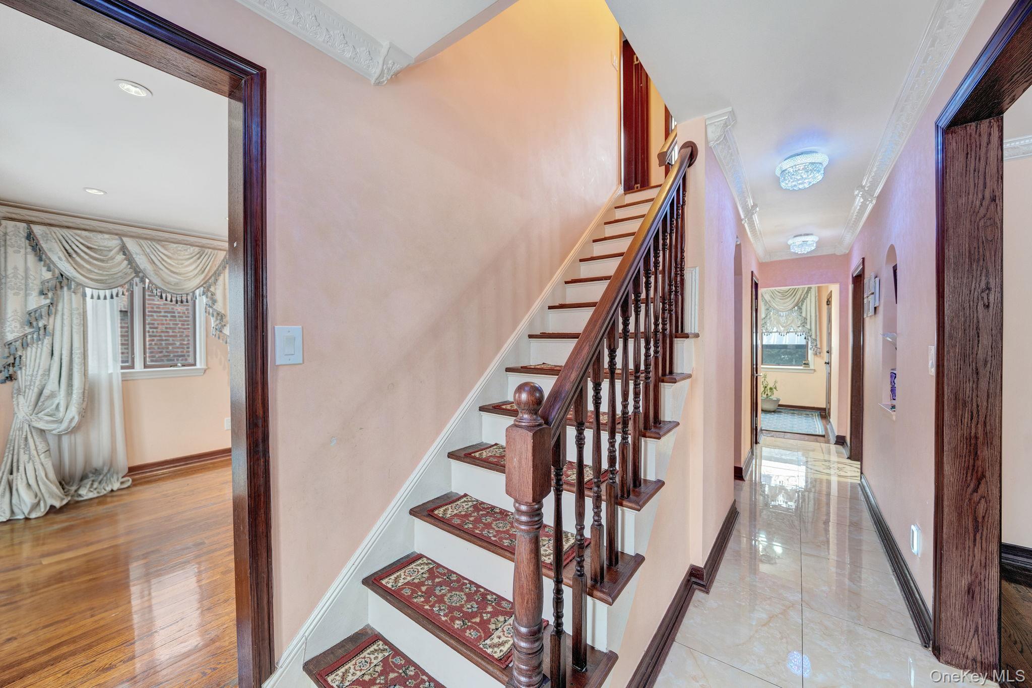 87-67 Chevy Chase Street Queens, NY 11432 - Photo 5 of 31 a view of a hallway with wooden floor and staircase
