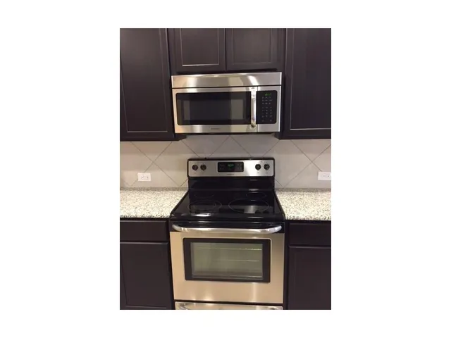 a kitchen with a stove and a microwave