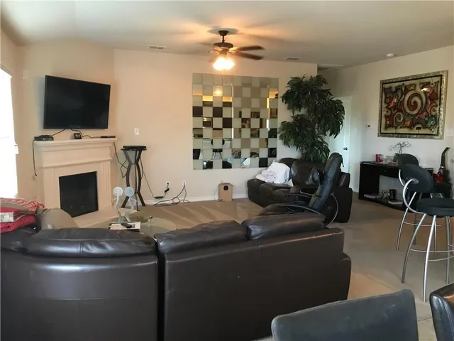 a dining room with furniture a fireplace and a flat screen tv