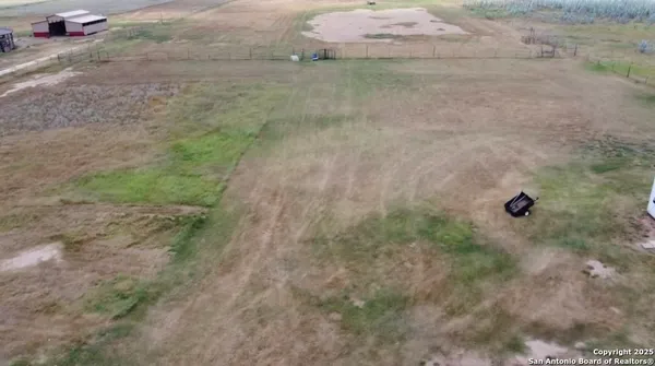 a view of a house with a truck parked in a yard