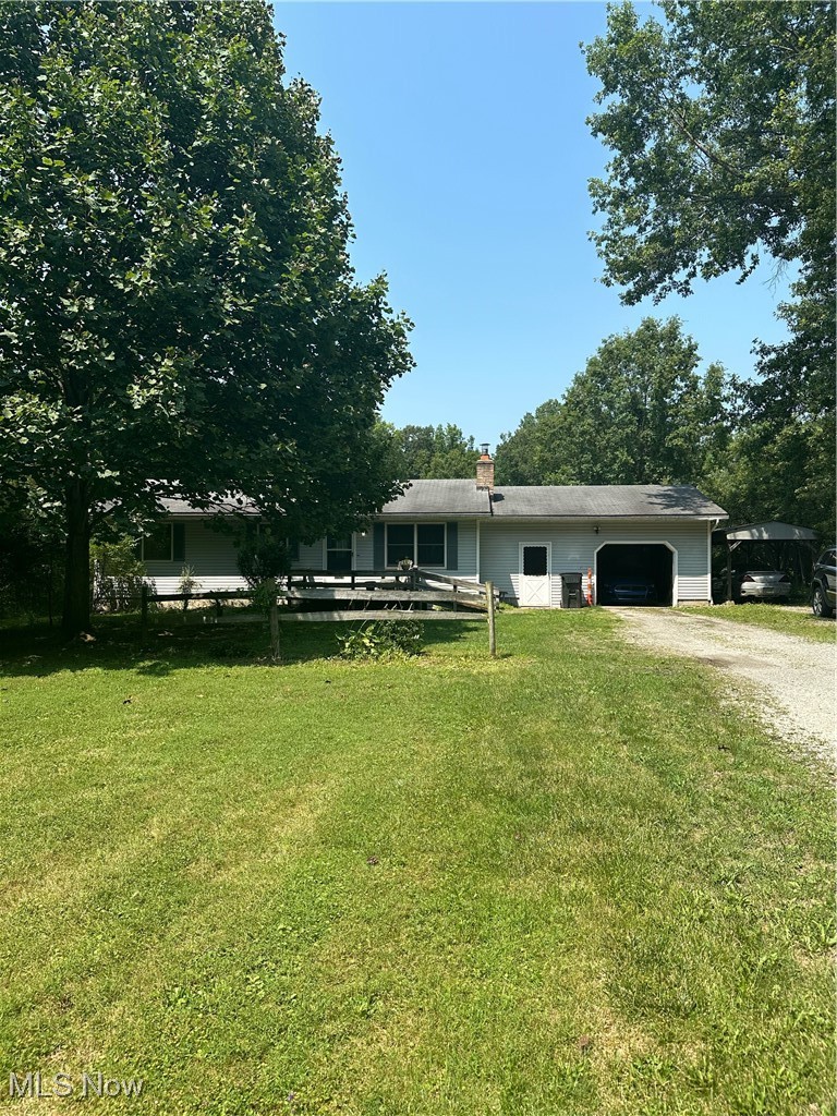 View of front of home featuring a garage and a front yard