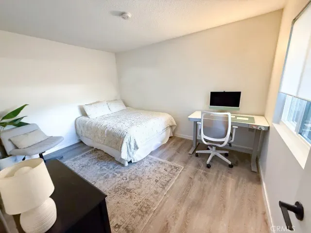 a bedroom with a bed and a chair