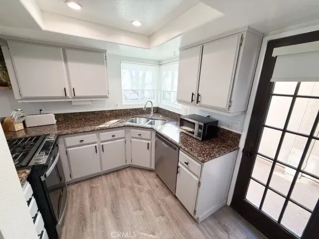 a kitchen with a sink stove and cabinets