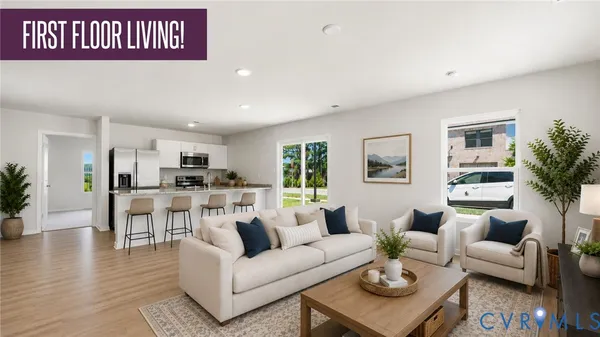 a living room with furniture and view of kitchen